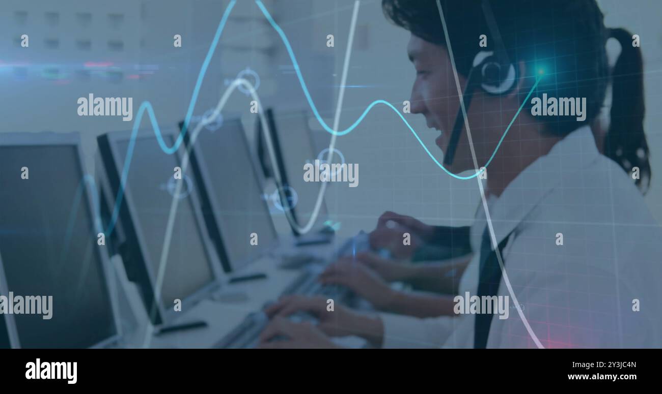 Image of financial data processing over asian businessman using phone headset and computer Stock Photo