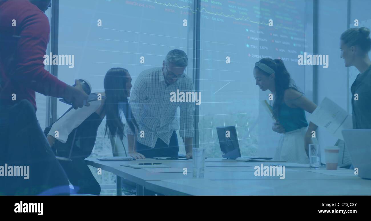 Image of financial data processing over diverse business people using laptop Stock Photo