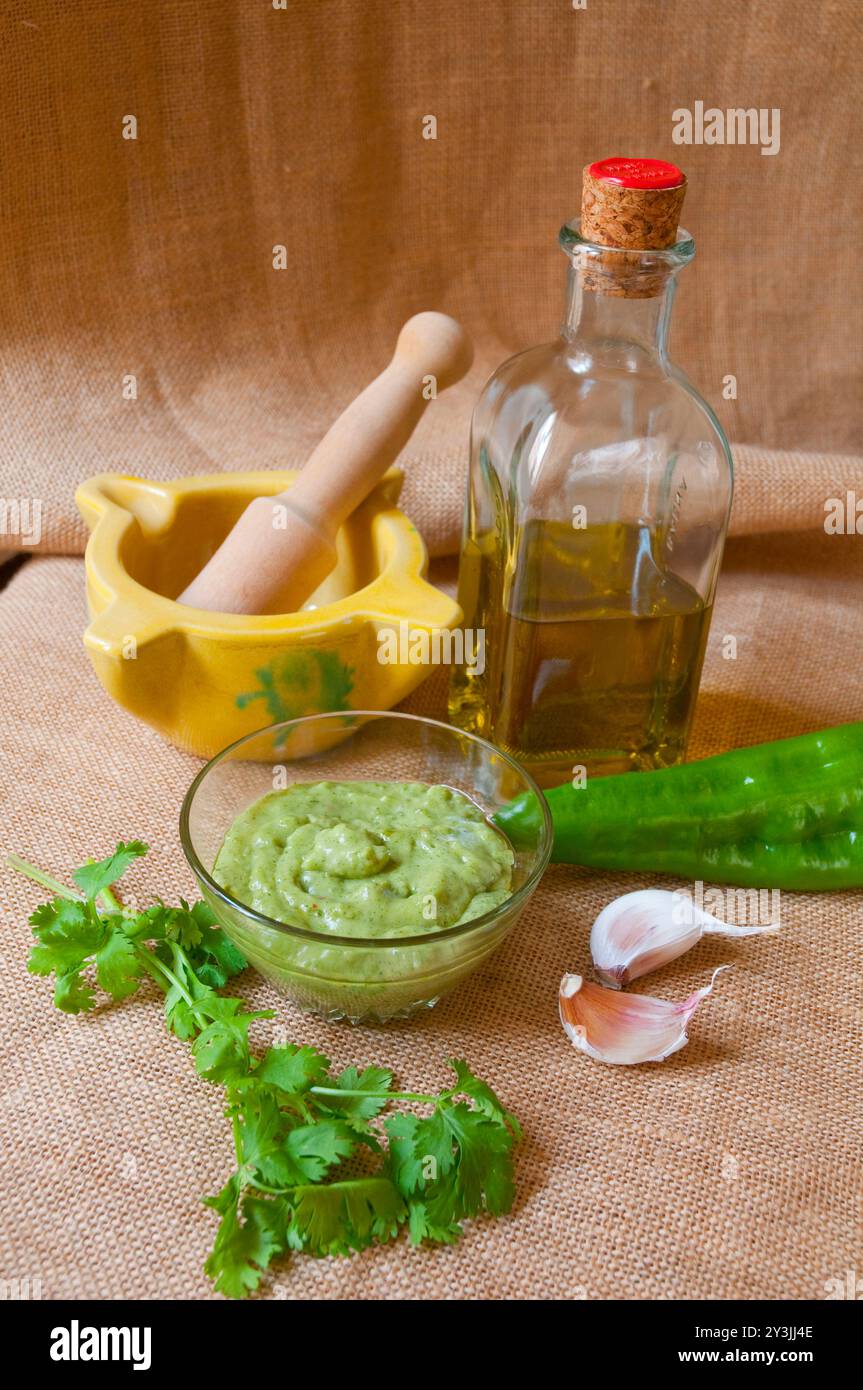 Green mojo with ingredients. Canary Islands, Spain. Stock Photo
