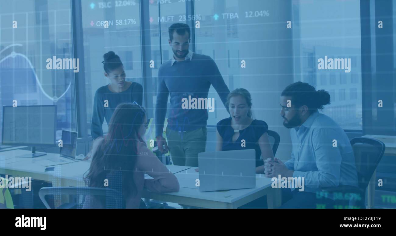 Image of financial data processing over diverse business people using laptop Stock Photo