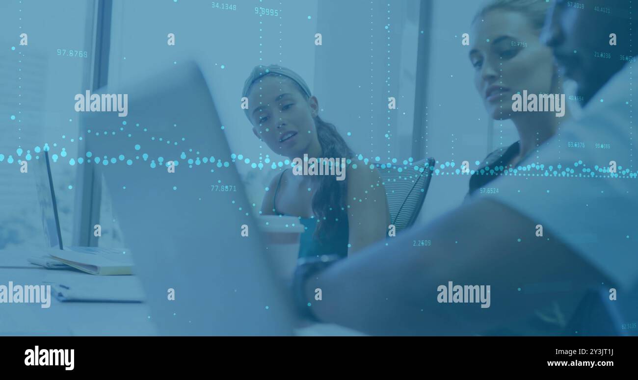 Image of financial data processing over diverse business people using laptop Stock Photo