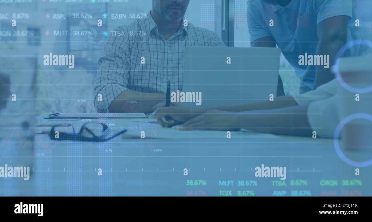 Image of financial data processing over diverse business people using laptop Stock Photo