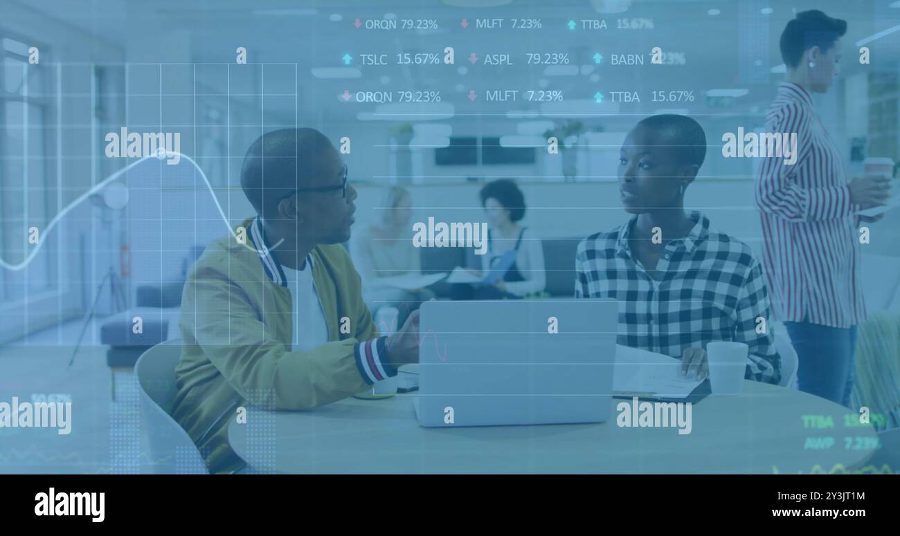 Image of financial data processing over diverse business people using laptop Stock Photo