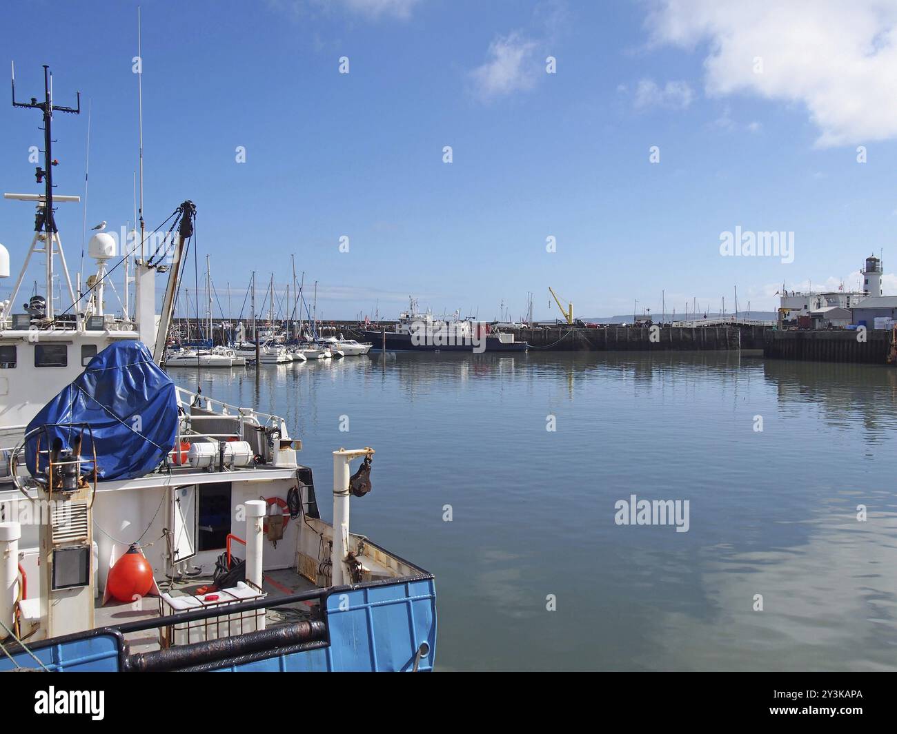 Trawler and leisure boats moored in Scarborough harbour and marina in summer sunlight Stock Photo