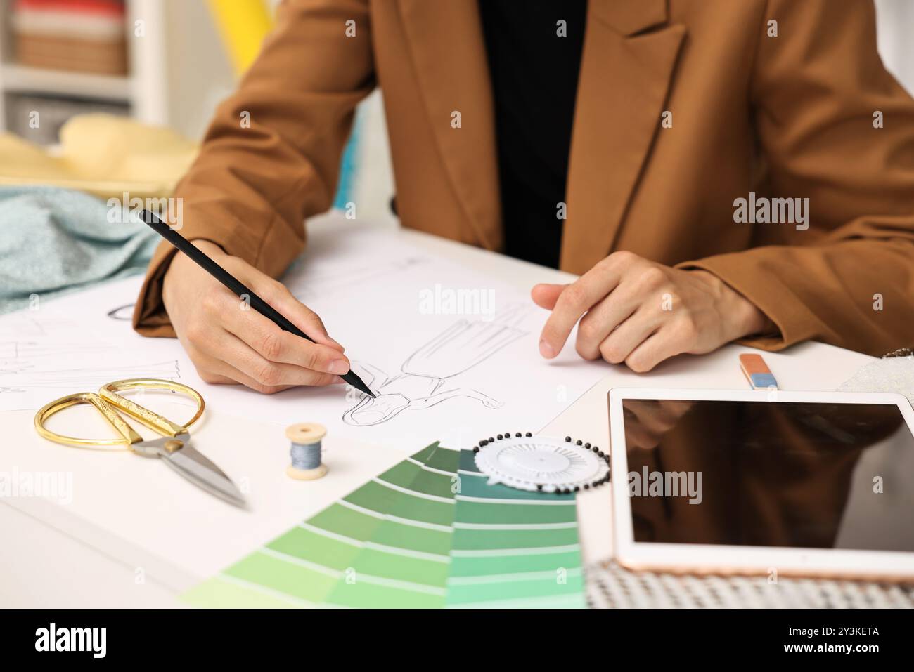 Fashion designer drawing sketch of dress at table, closeup Stock Photo ...
