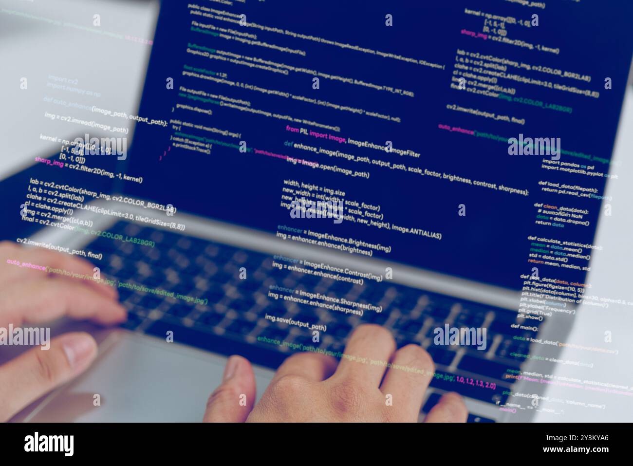 Hands typing code on a laptop, showcasing a software developer at work. Represents process of programming and software development. Ideal for tech blo Stock Photo