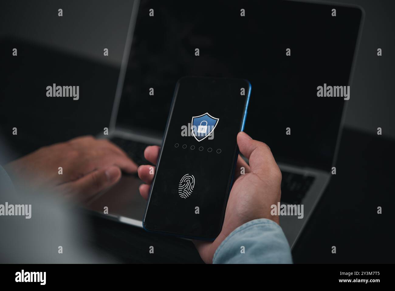 Person using smartphone with fingerprint authentication, ensuring digital security. Modern mobile technology for identity verification, data protectio Stock Photo