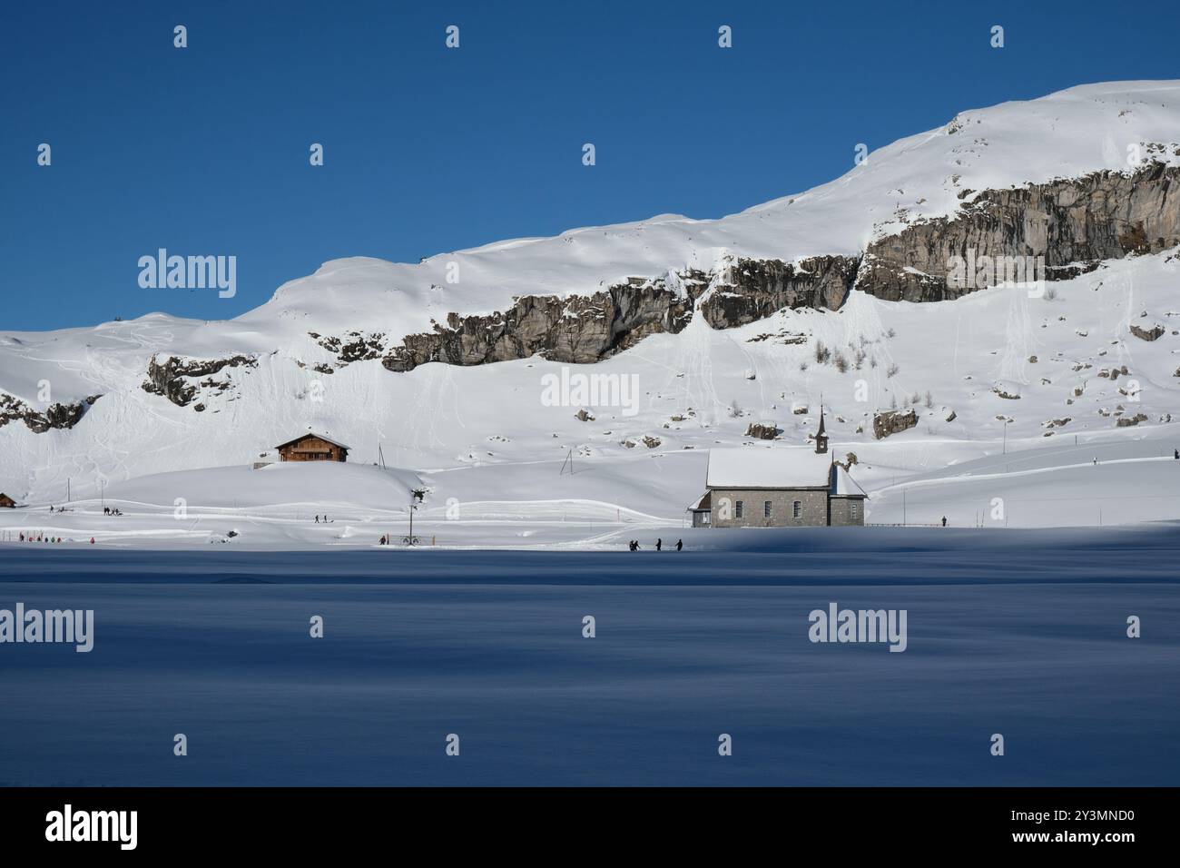 Church in the Swiss Skiing and Winter Sport Region Melchsee Frutt in the Evening, Half in Shade. Stock Photo