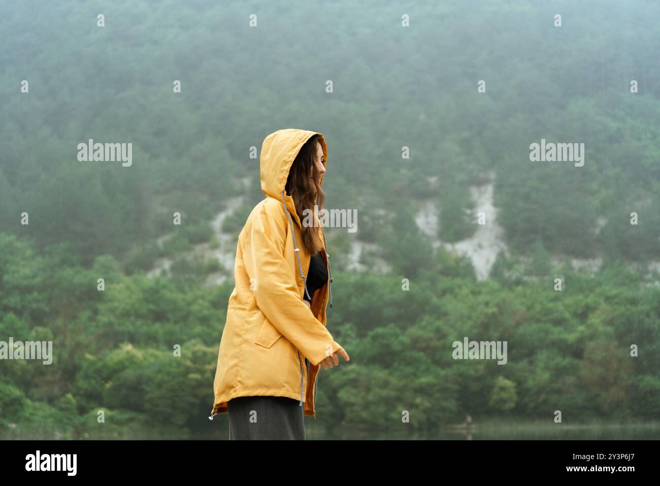 Sad woman in yellow raincoat hi-res stock photography and images - Alamy