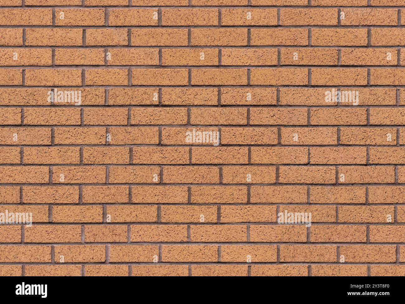 Brown brick wall seamless background texture image. Traditional block masonry surface. A modern interior and exterior and backdrop tile design. Stock Photo