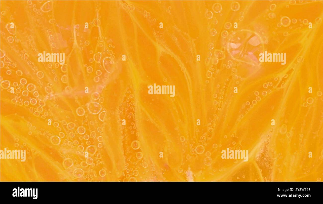 Slice an orange in bubble water. Slice of orange in carbonated water. Party concept, summer, holiday, birthday Stock Photo
