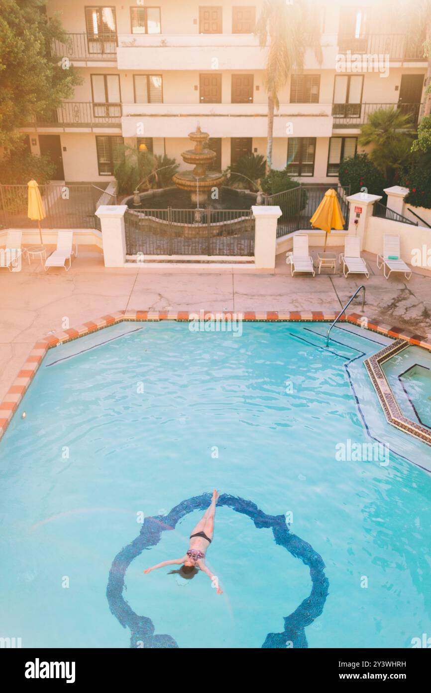 A top down view of a woman floating in a hotel pool Stock Photo - Alamy