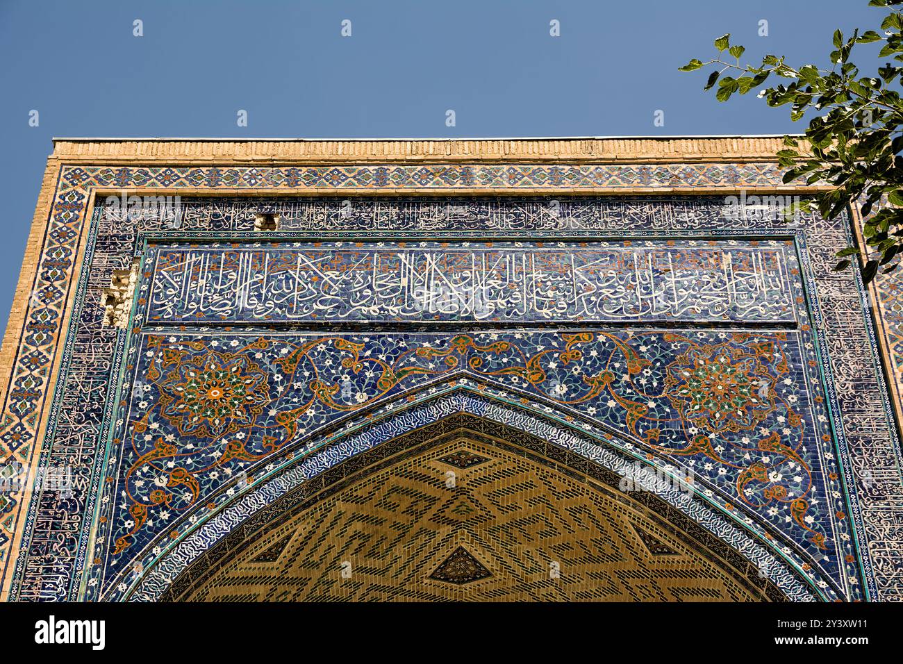 Detail with Arabic writings from the Koran at the entrance portal to a madrassa at the Registan in Samarkand Stock Photo