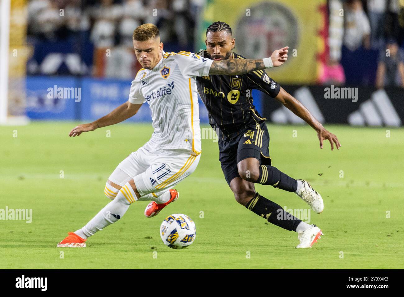 Los Angeles, United States. 14th Sep, 2024. LA Galaxy's Gabriel Pec (L) and Los Angeles FC's Eddie Segura (R) vie for the ball during an MLS soccer match at Dignity Health Sports Park. Credit: SOPA Images Limited/Alamy Live News Stock Photo