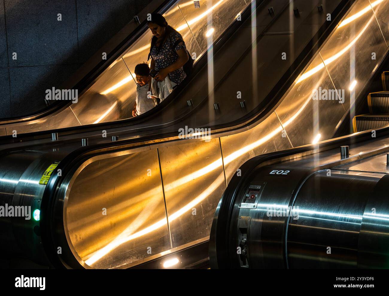 Going down an escalator in a subway station Stock Photo