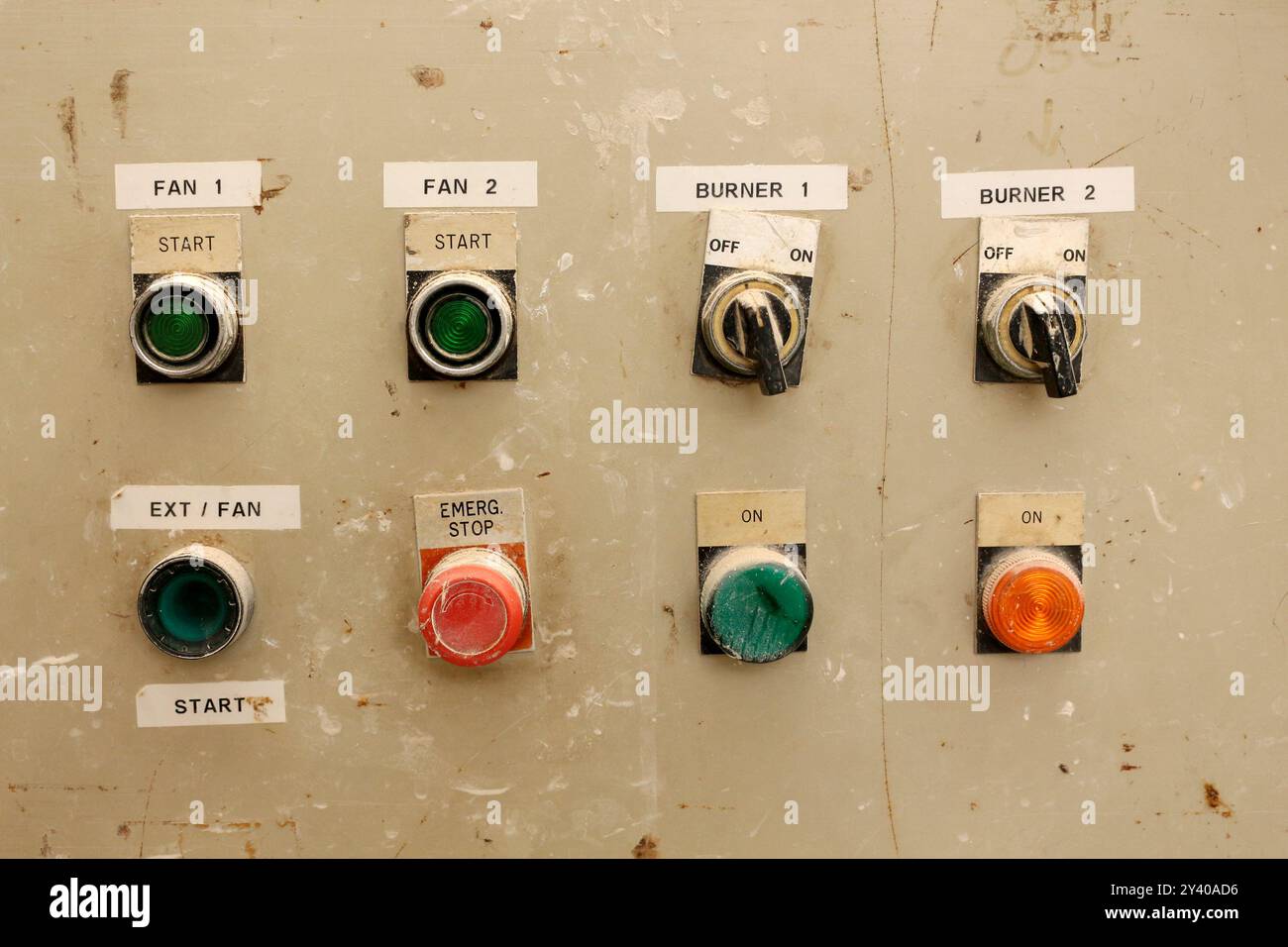 Close-up of a vintage industrial control panel with various buttons and ...