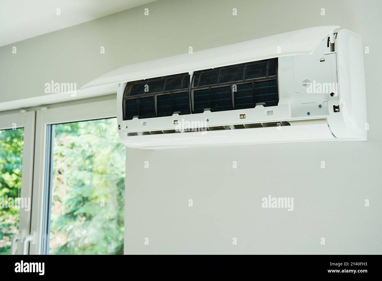 White air conditioner unit is mounted on wall, ready for maintenance ...