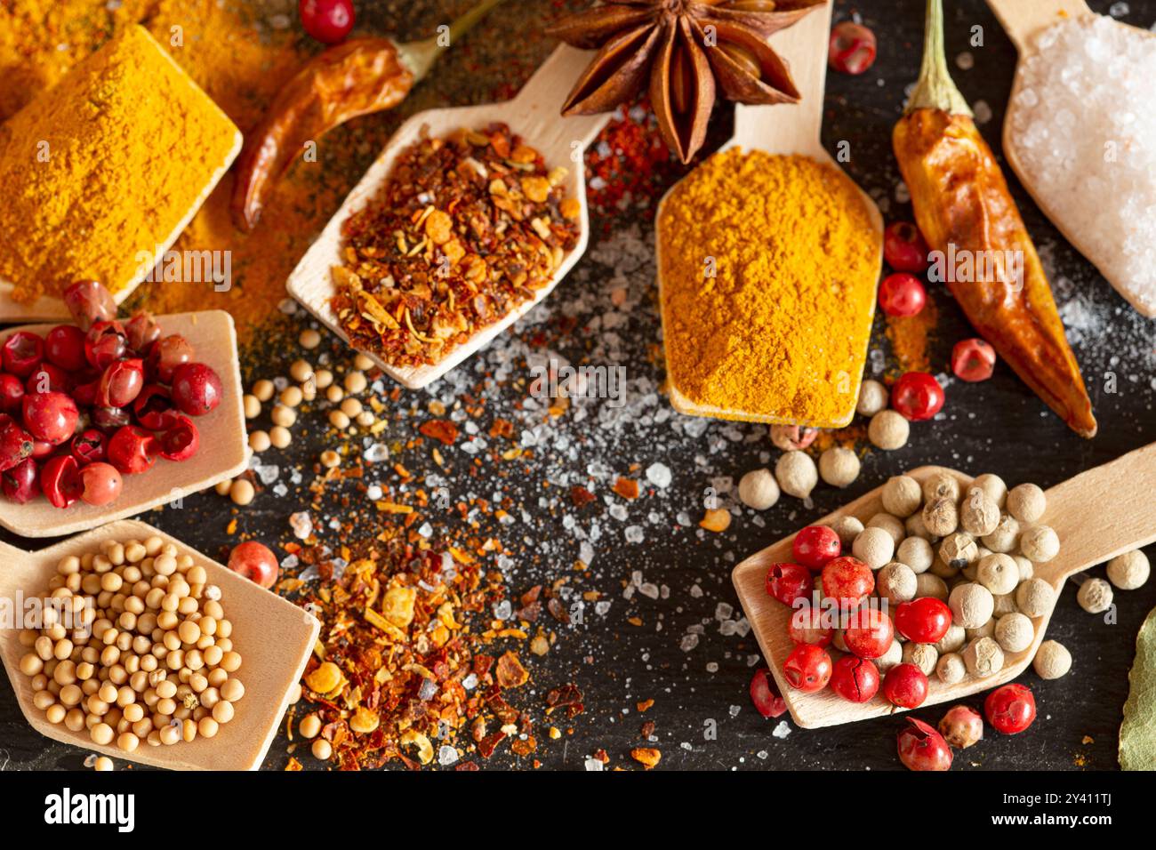 Various spices in wooden spoons Stock Photo