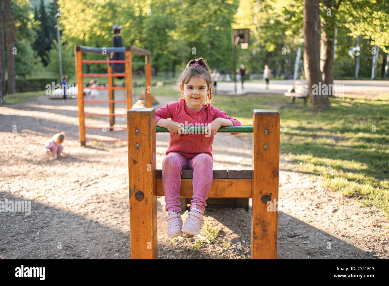 Active cute little girl on the playground Stock Photo - Alamy