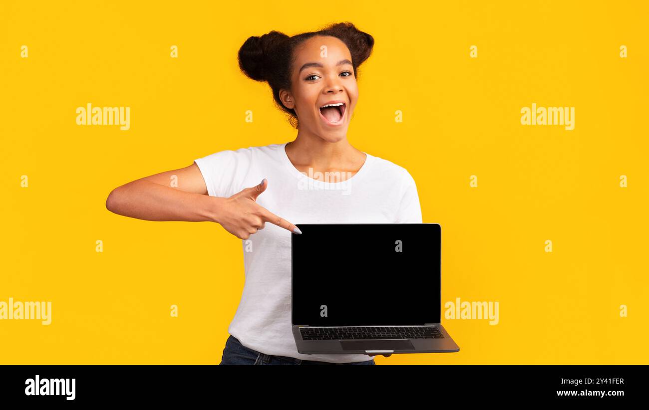 Happy african teenager pointing at blank laptop screen Stock Photo - Alamy