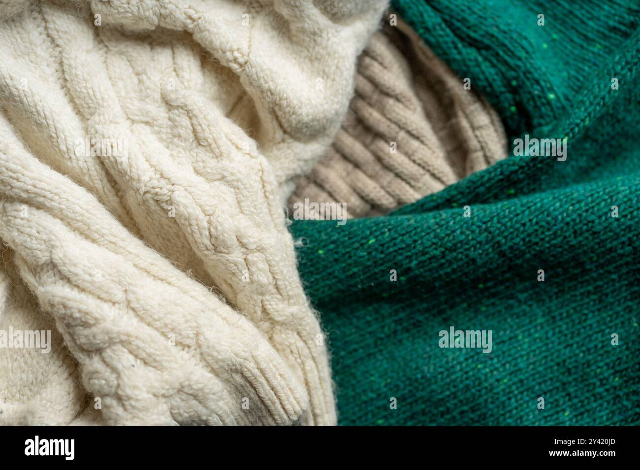 Two hand knitted wool sweaters. Background textures. Stock Photo