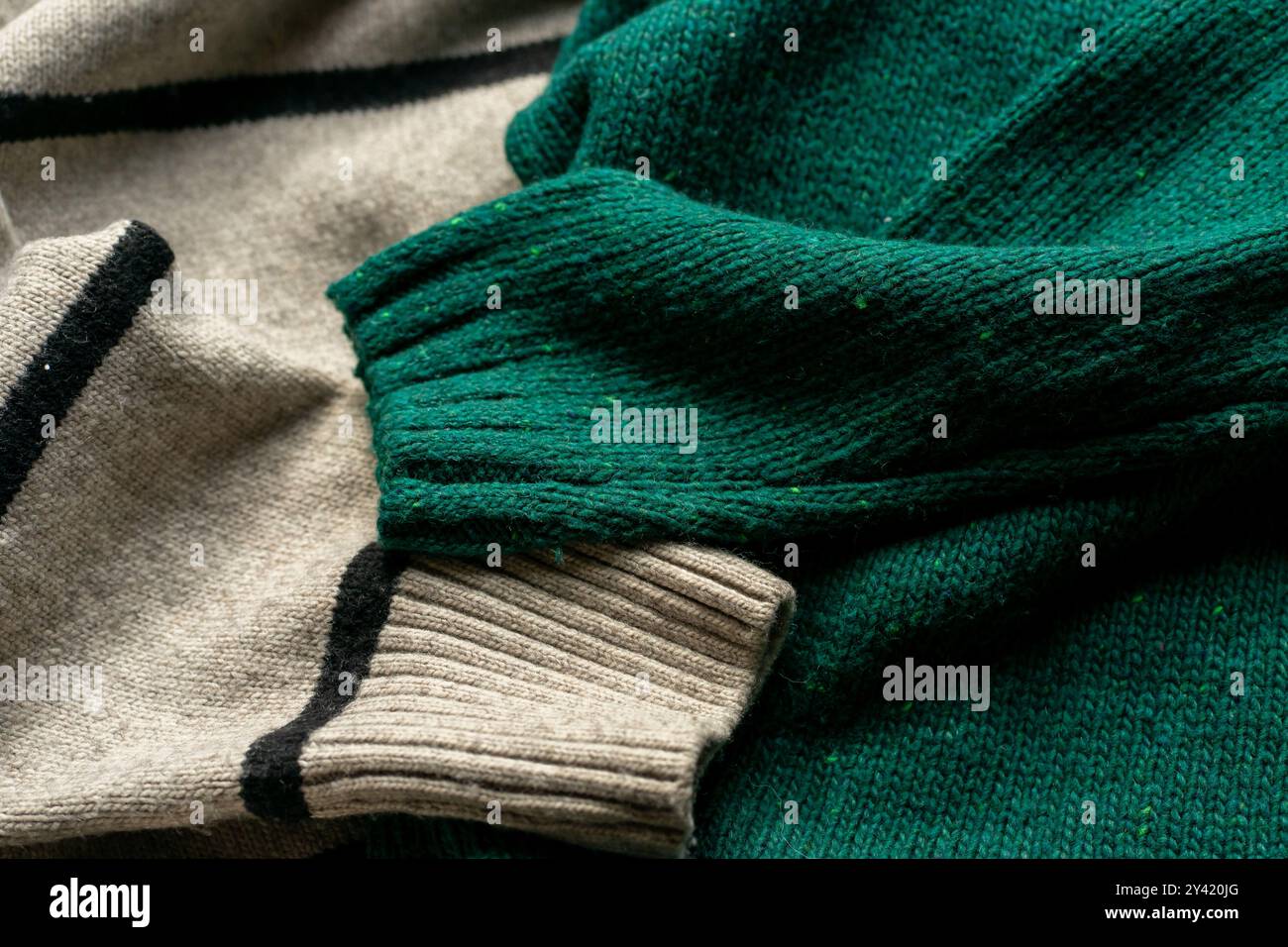 Two hand knitted wool sweaters. Background textures Stock Photo