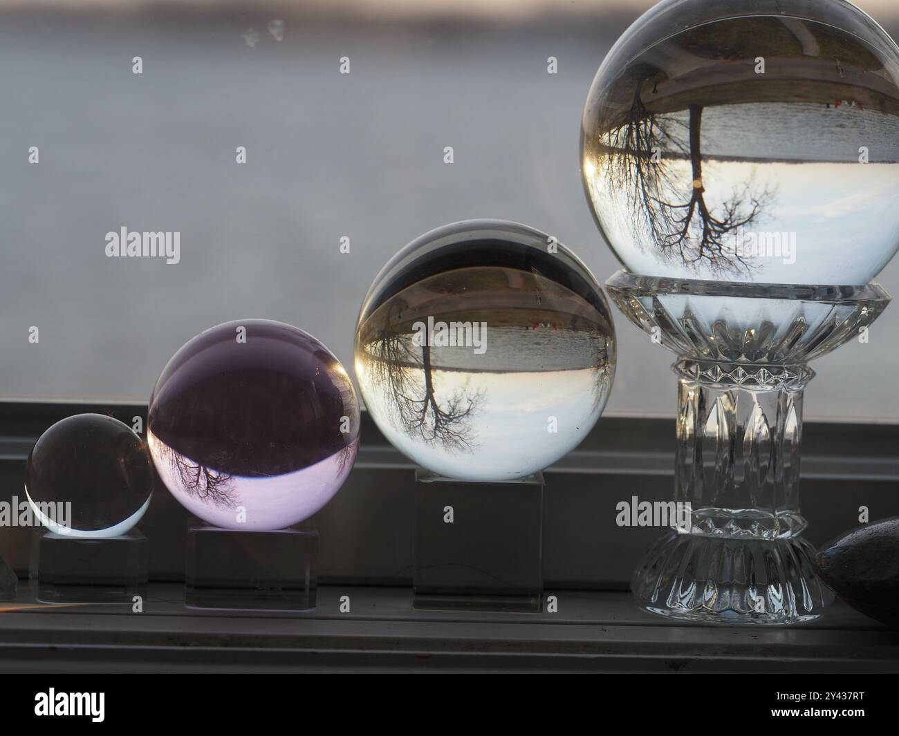Glass orb reflecting sunset over water hi-res stock photography and ...