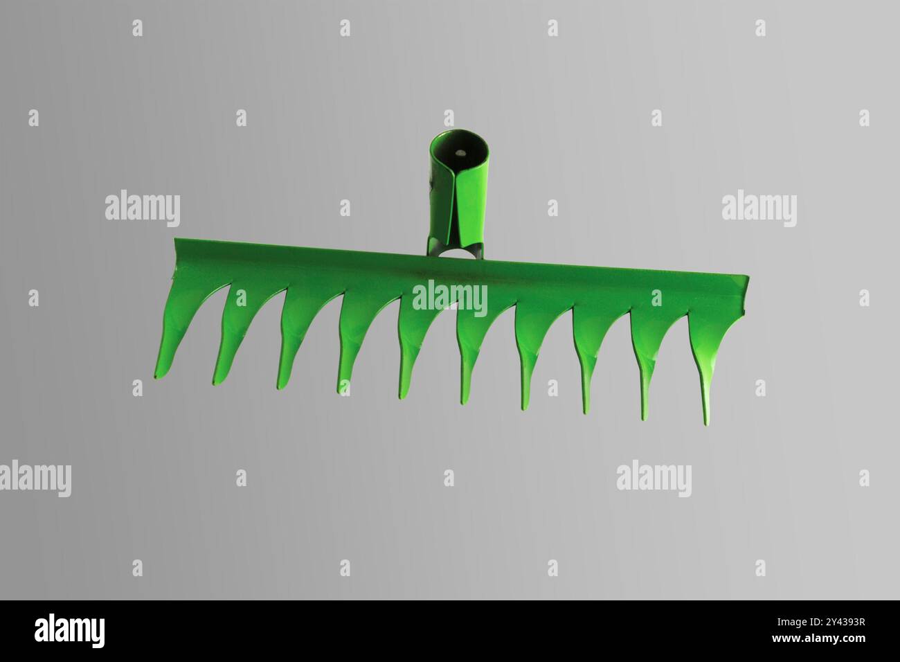 Green garden rake. Close-up. Isolated on a gray background Stock Photo ...