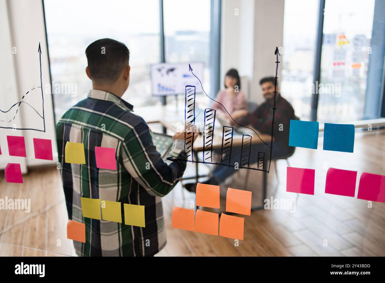 Team brainstorming session with charts and sticky notes Stock Photo - Alamy