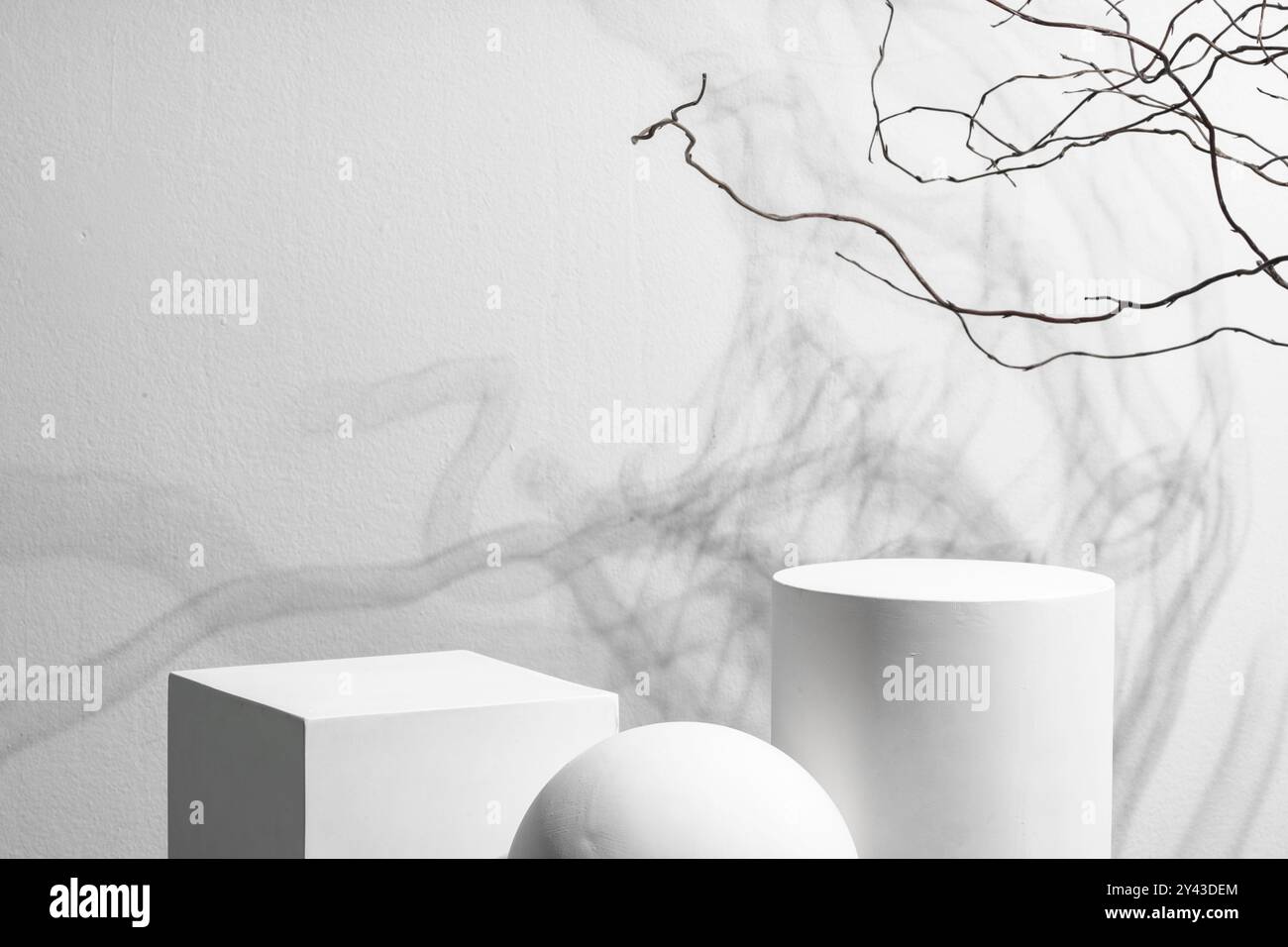 Abstract composition featuring three white geometric shapes in a ...