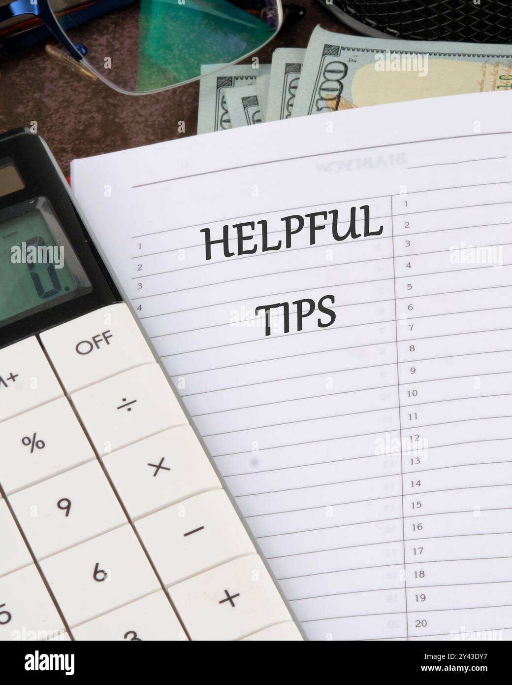 Helpful Tips words in a notebook in a ruler on a blank sheet Stock Photo