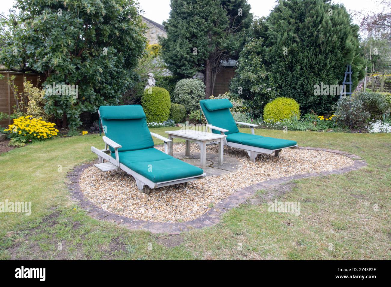 Photo of a typical British garden showing a seating area with sun loungers in the UK garden Stock Photo