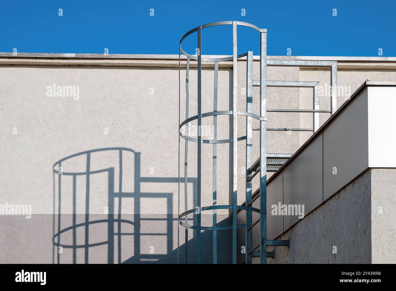 Fixed steel caged ladder on industrial building, selective focus Stock Photo