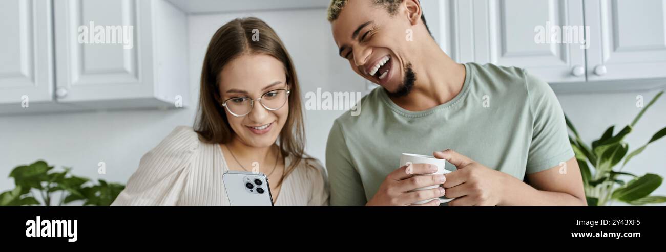 Friends enjoying a lighthearted conversation while sharing a drink. Stock Photo