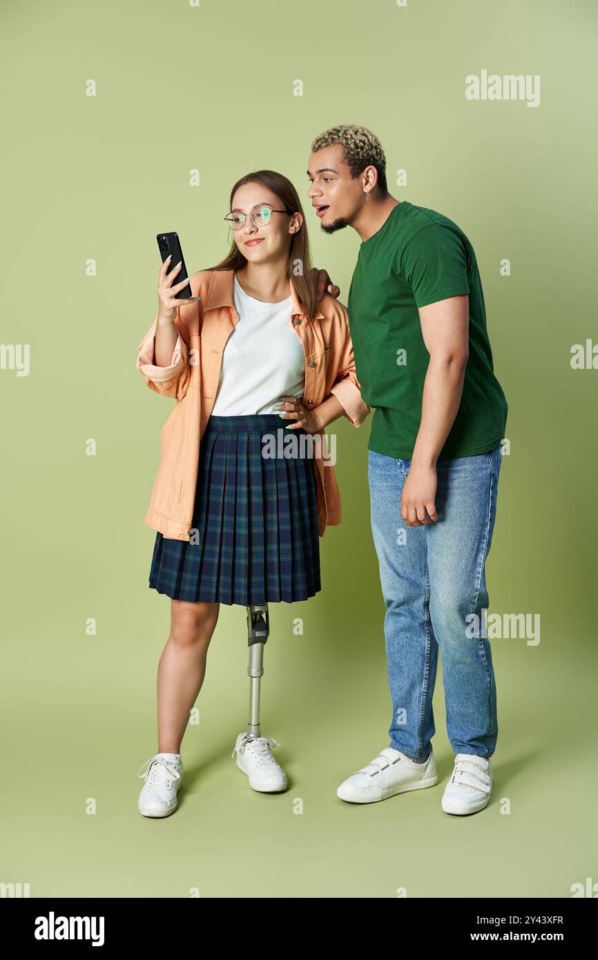 Two friends share a moment while interacting over a smartphone. Stock Photo
