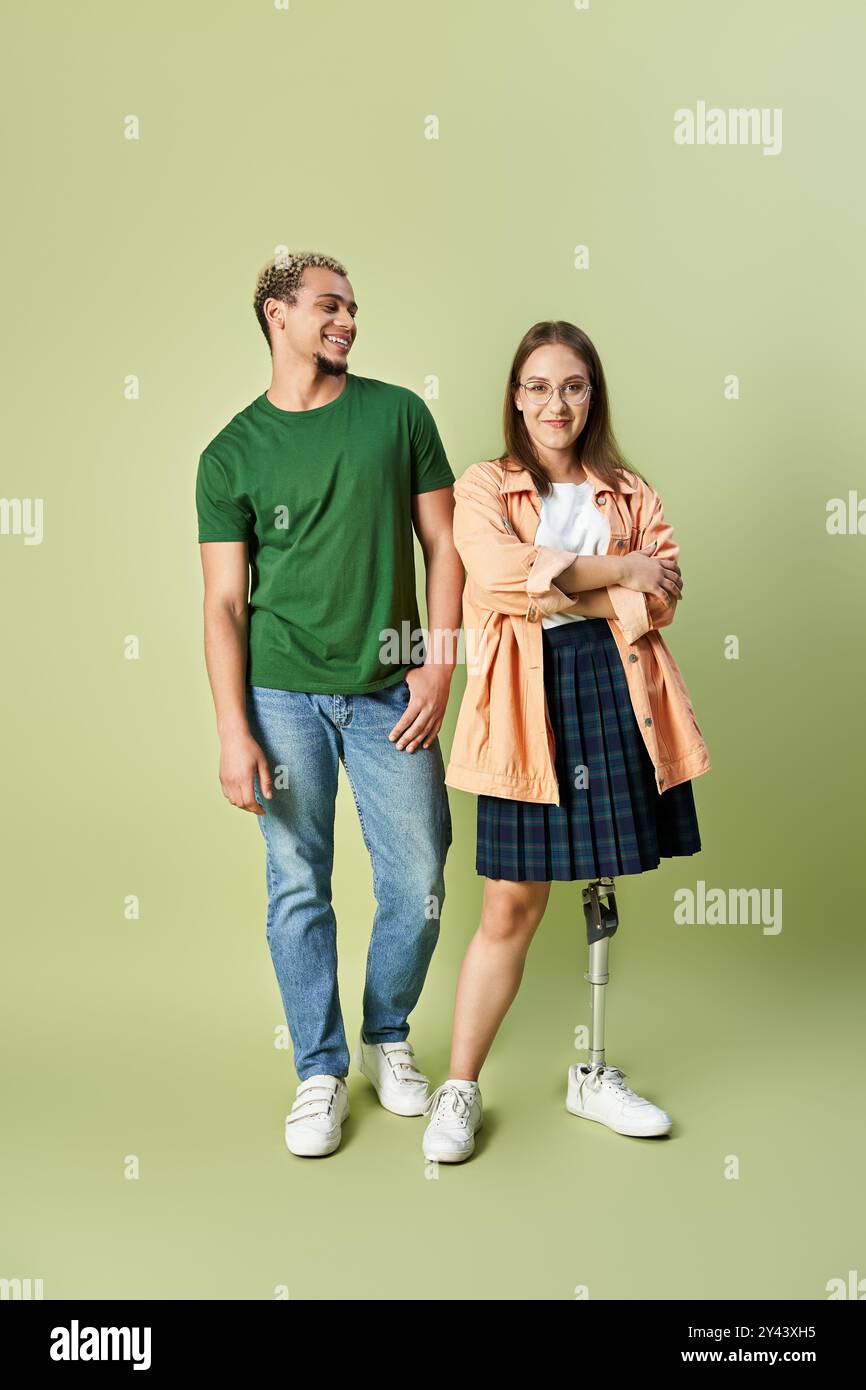 A non binary person smiles next to their friend with a prosthetic leg ...