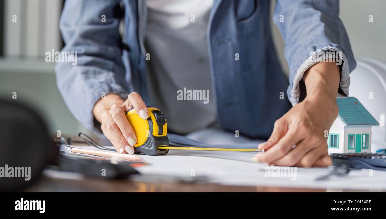Civil Engineer Measuring Dimensions for Structural Accuracy in Building ...