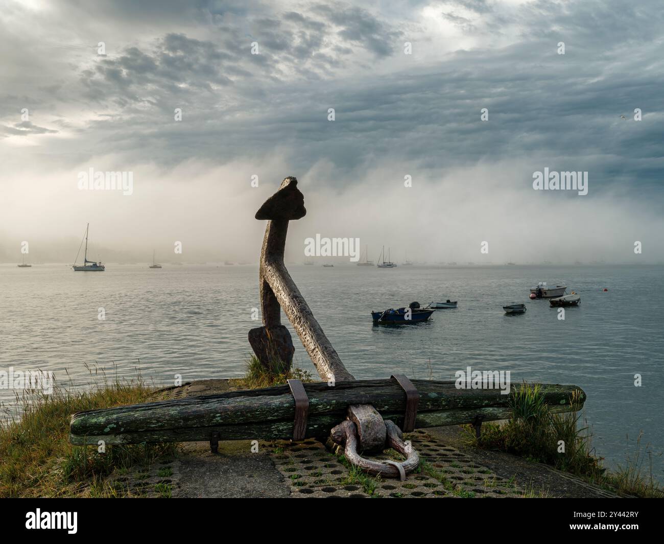 Appledore North Devon - Just after sunrise, beyond the quayside anchor, a thick bank of mist rolls along the River Torridge estuary at Appledore North Stock Photo