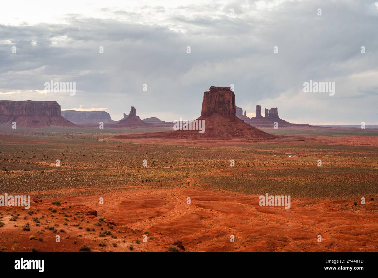 Dramatic buttes rise in Monument Valley's vast, red desertscape. Stock Photo