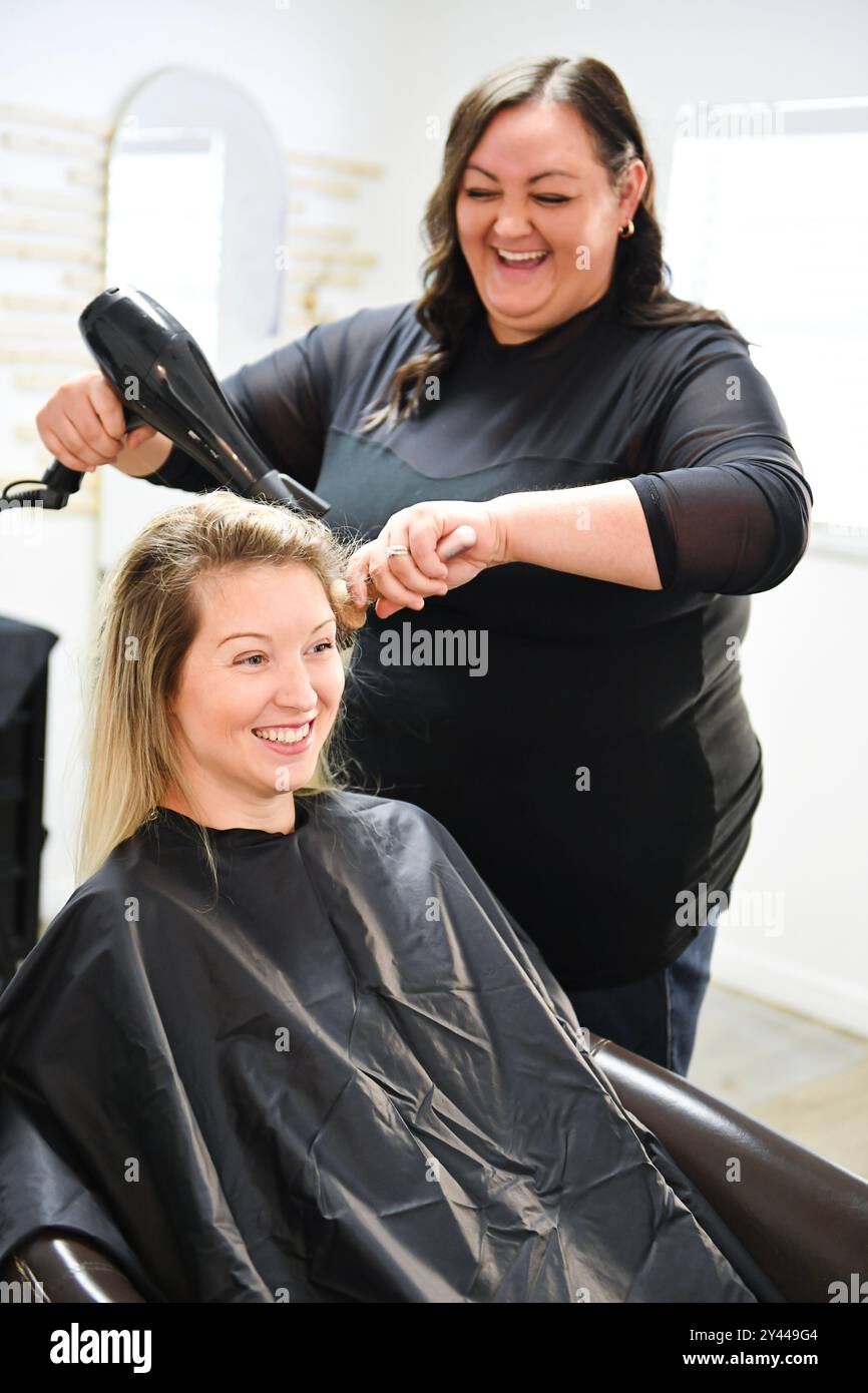 Female hairdresser blow drying hi-res stock photography and images - Alamy
