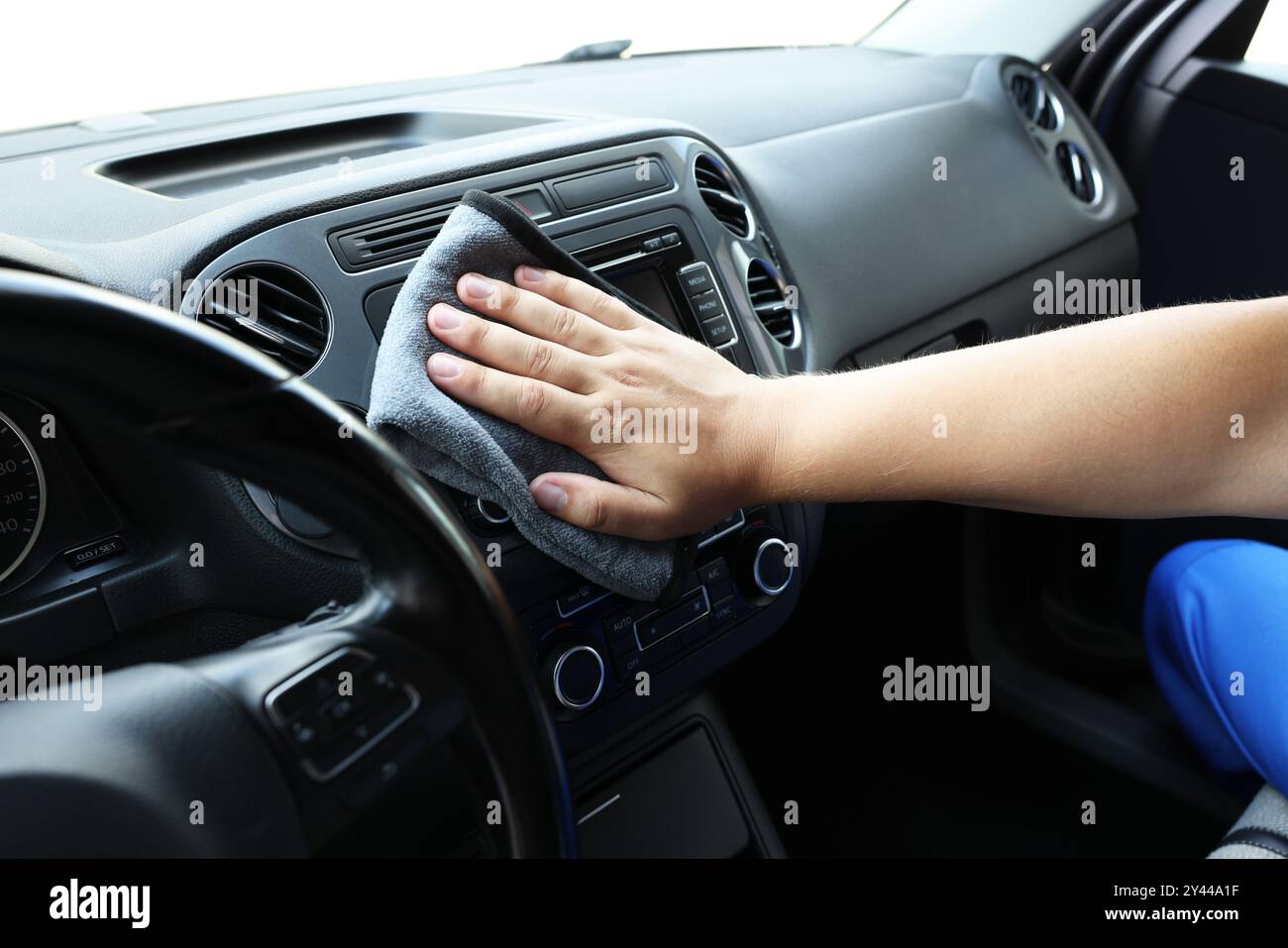 Man cleaning center console with rag, closeup Stock Photo - Alamy