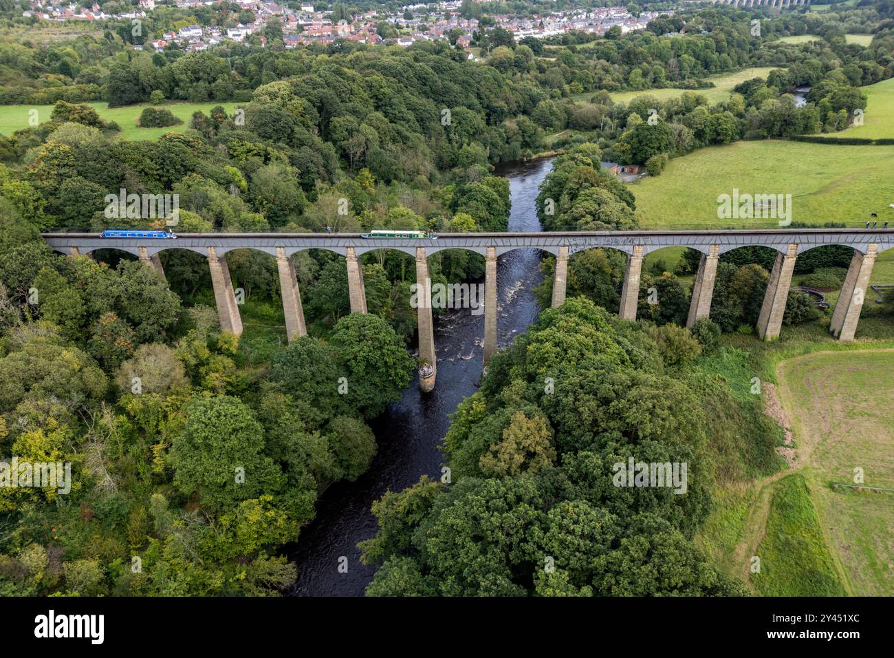 Narrow boats pass over the Pontcysyllte Aqueduct in North Wales, its 19  cast-iron spans carry the waterway 126 feet / 38.4 metres above the river. Stock Photo