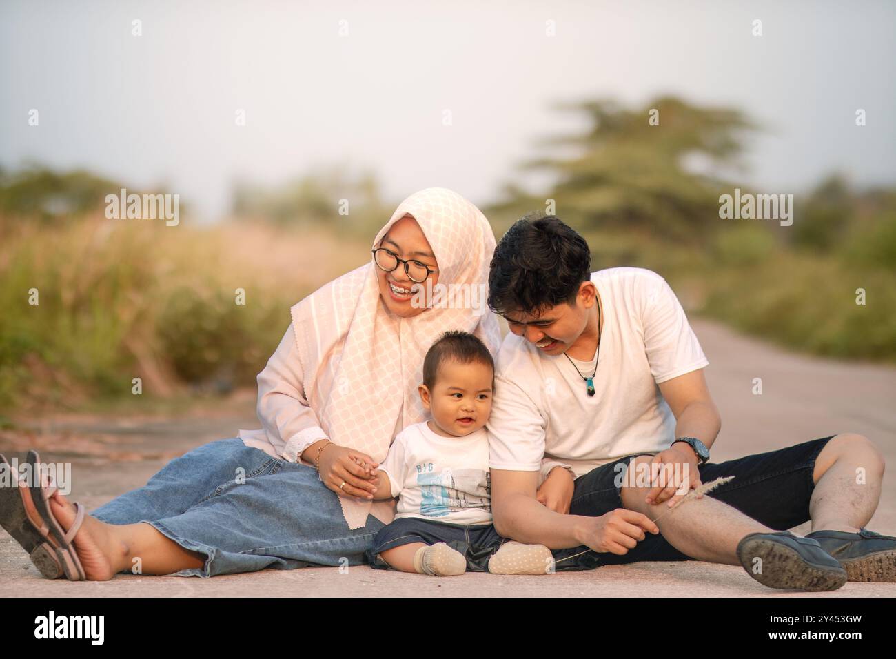 A family that looks happy with lots of laughter with mom, dad and baby ...