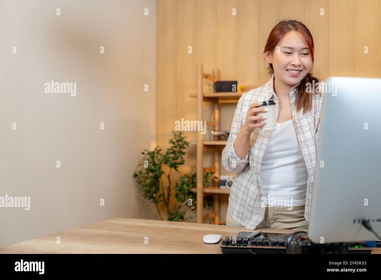 a-woman-working-with-video-editor-at-home-2Y45K33.jpg