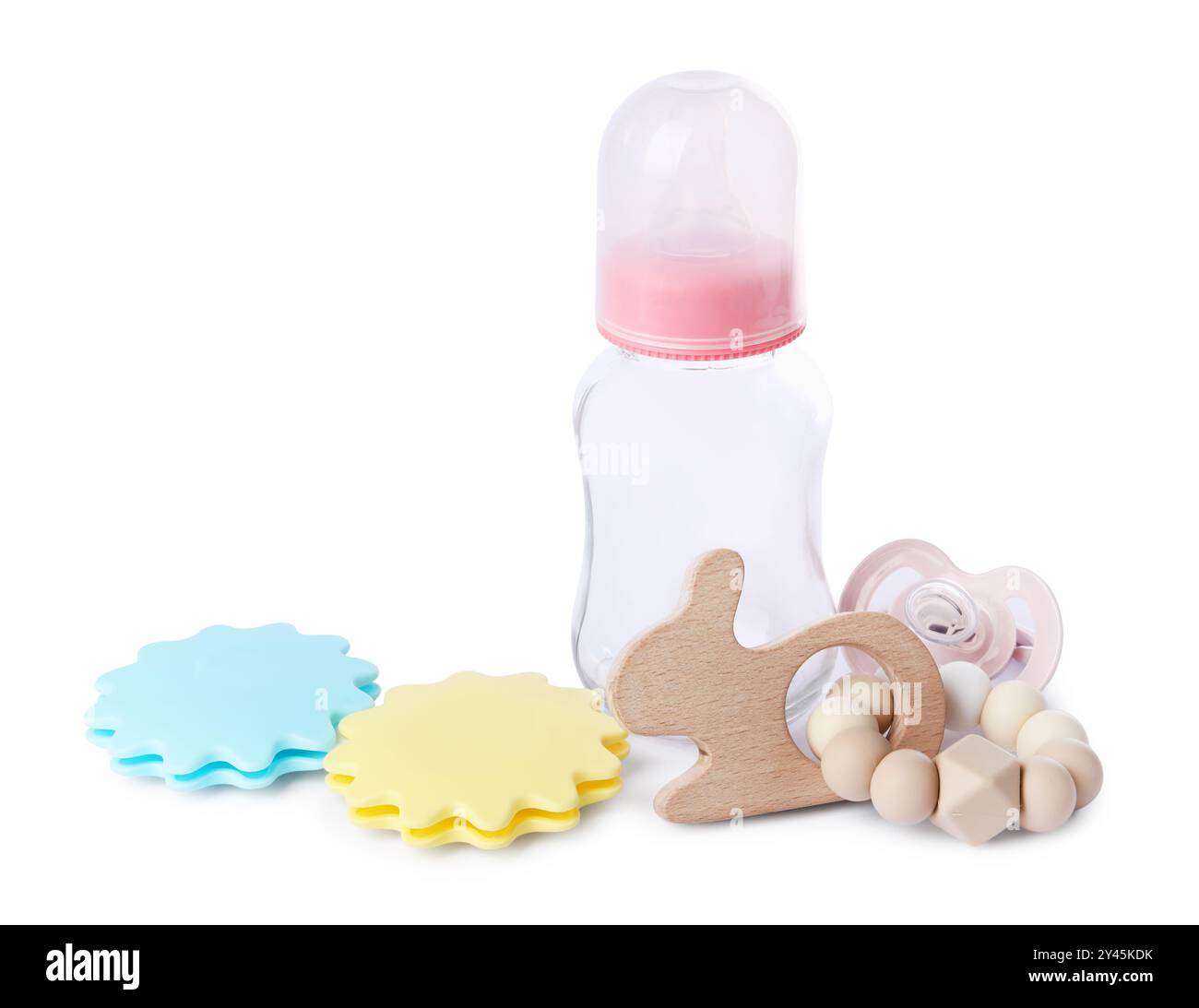 Colorful rattles, bottle and pacifier isolated on white. Baby ...