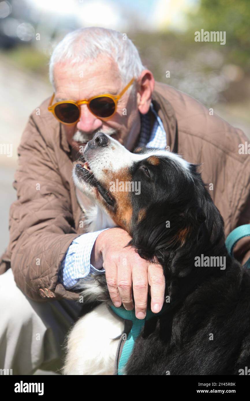 portrait of a senior man bonding with his dog outdoors Stock Photo - Alamy