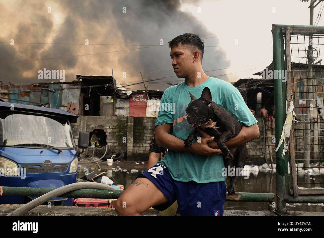 Fire in informal settlement in Manila, Philippines A man carries his ...