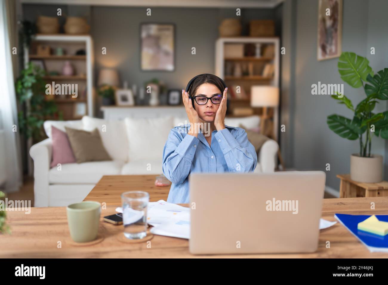 Young businesswoman small company owner, frustrated about statistics. Worried business female, freelancer, finance and economy expert, having issue an Stock Photo