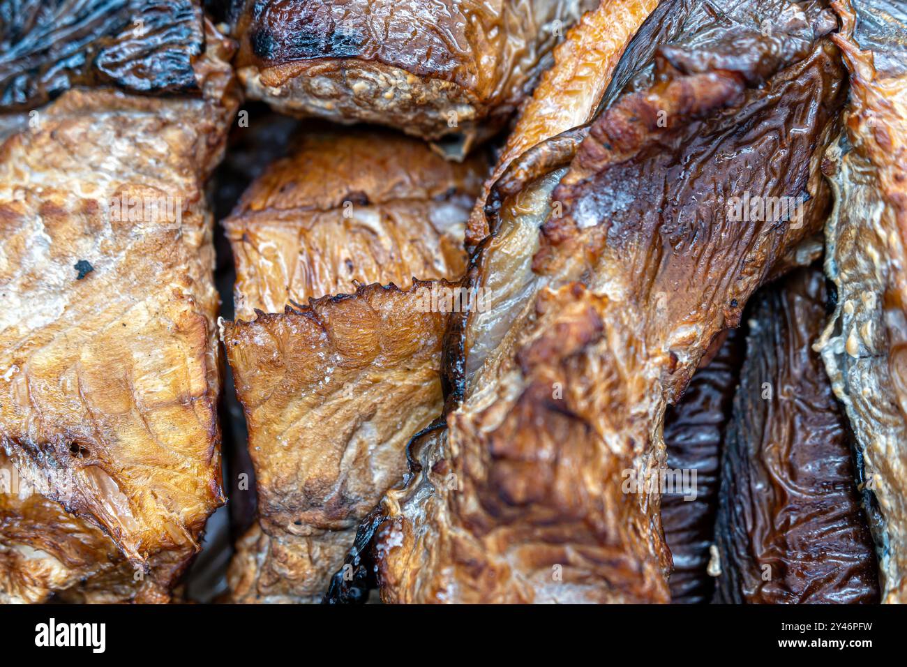 Close-up view of dried fish with rich textures and warm tones, highlighting their natural hues. Stock Photo