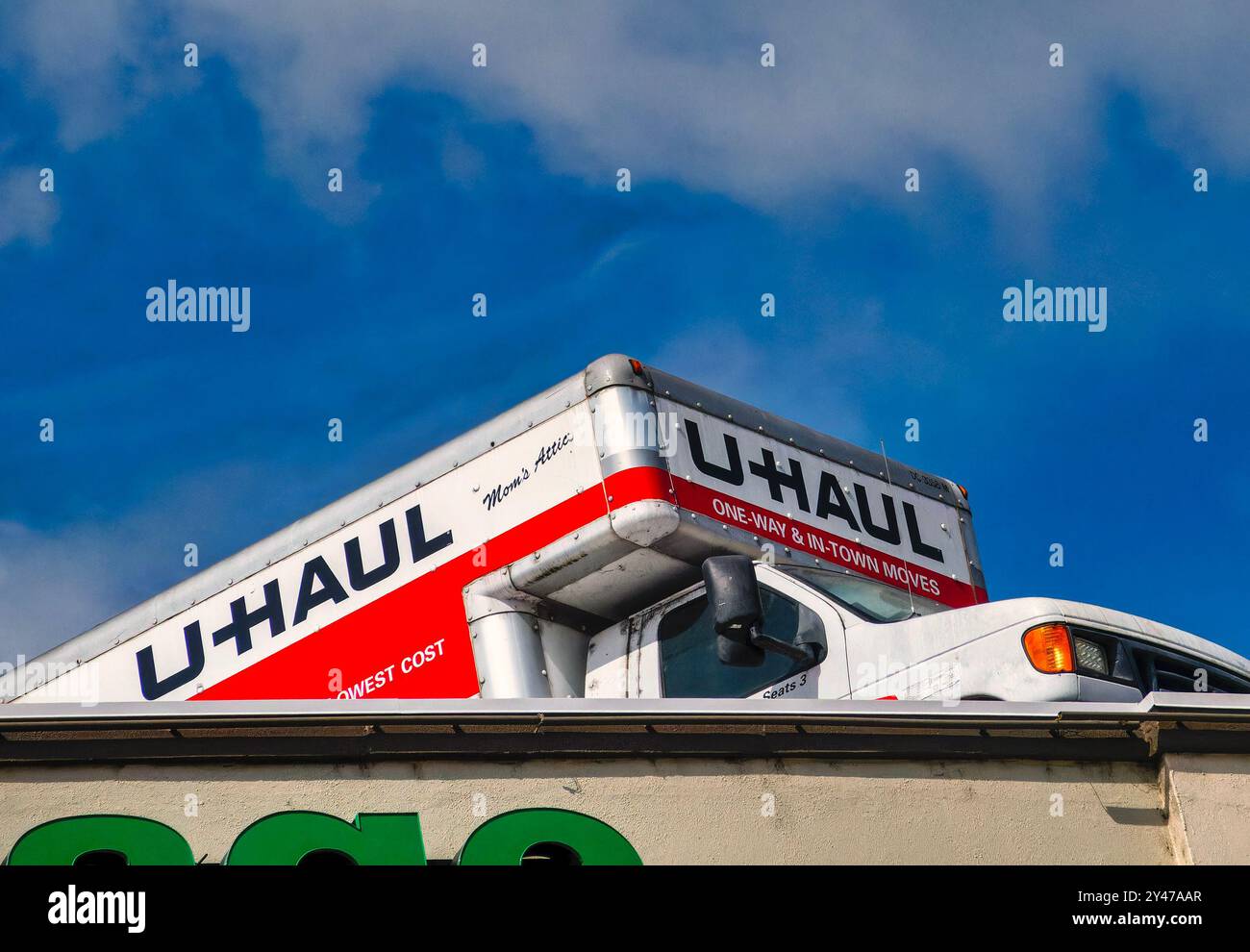 UHail moving vans parked at an angle on a building roof. Stock Photo